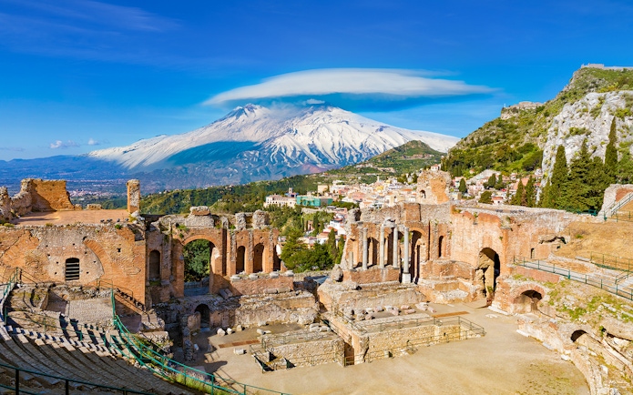 Ancient Greek Theatre in Taormina with Mount Etna in the background, Sicily.