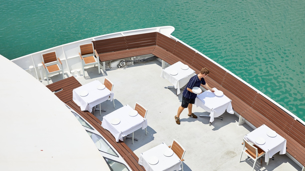 Lunch tables set on a boat deck for Darwin Harbour cruise.
