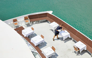 Lunch tables set on a boat deck for Darwin Harbour cruise.