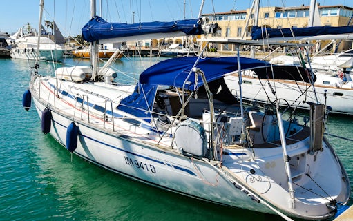 Sailboat docked in La Maddalena Archipelago marina.