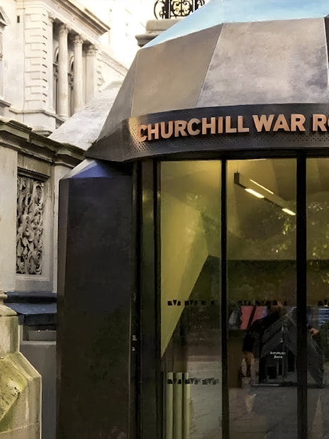 Entrance to Churchill War Rooms in London with ornate stone staircase.