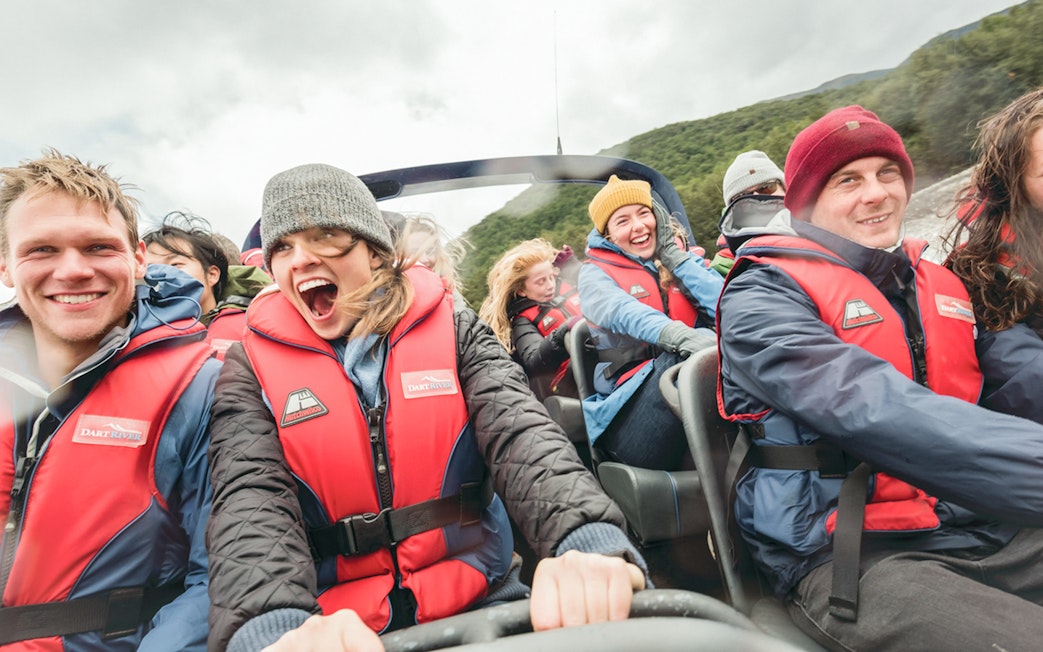 Group enjoying Dart River Wilderness Jet Experience in New Zealand, wearing life jackets.