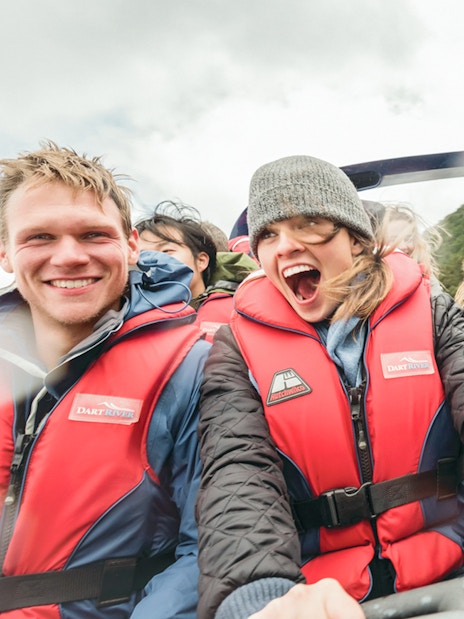 Group enjoying Dart River Wilderness Jet Experience in New Zealand, wearing life jackets.