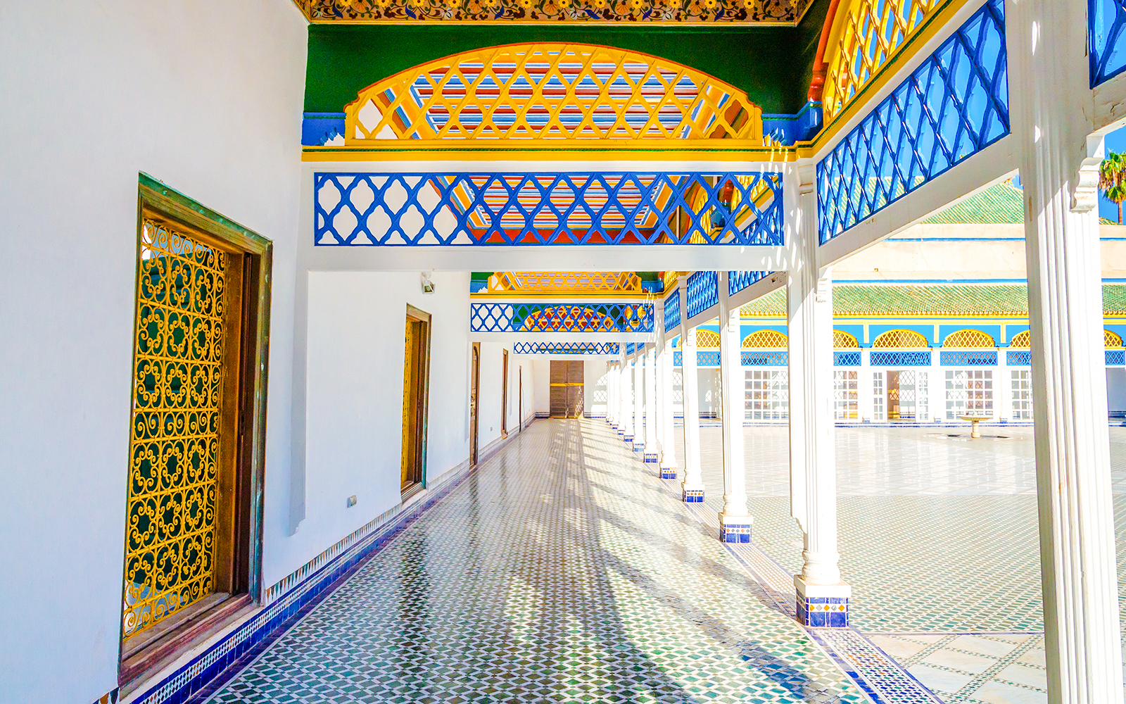 Bahia Palace courtyard with colorful arches and tiled floor in Marrakech, Morocco.