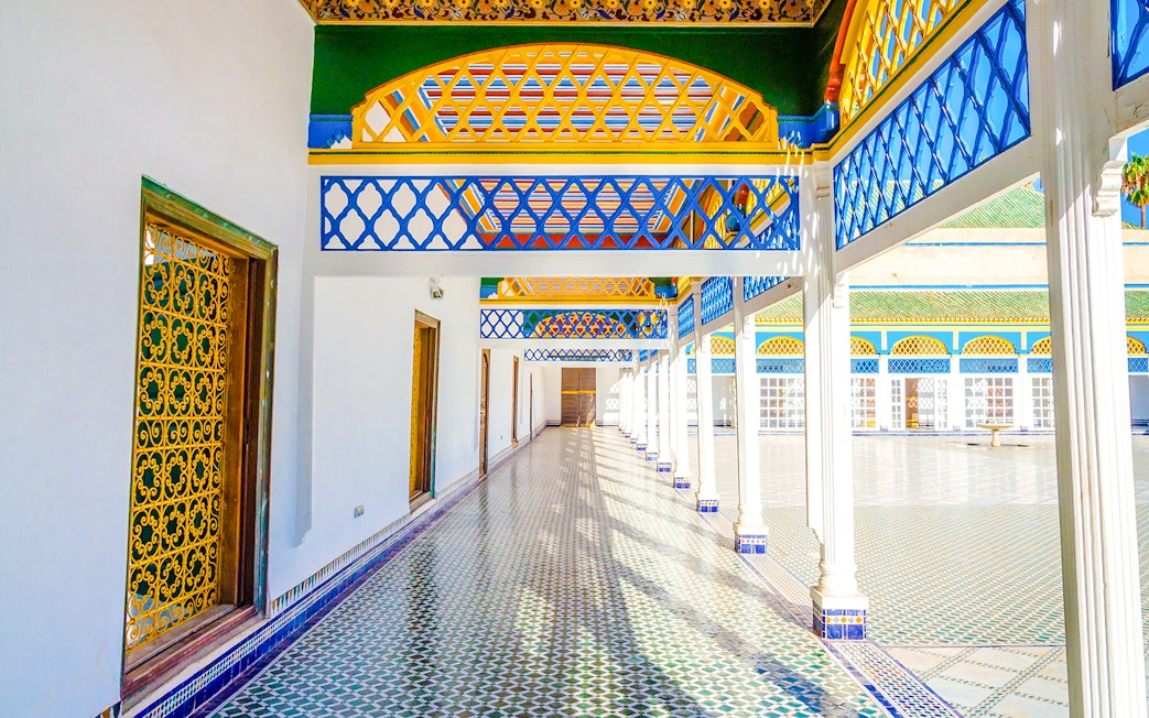 Bahia Palace courtyard with colorful arches and tiled floor in Marrakech, Morocco.