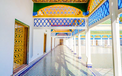 Bahia Palace courtyard with colorful arches and tiled floor in Marrakech, Morocco.