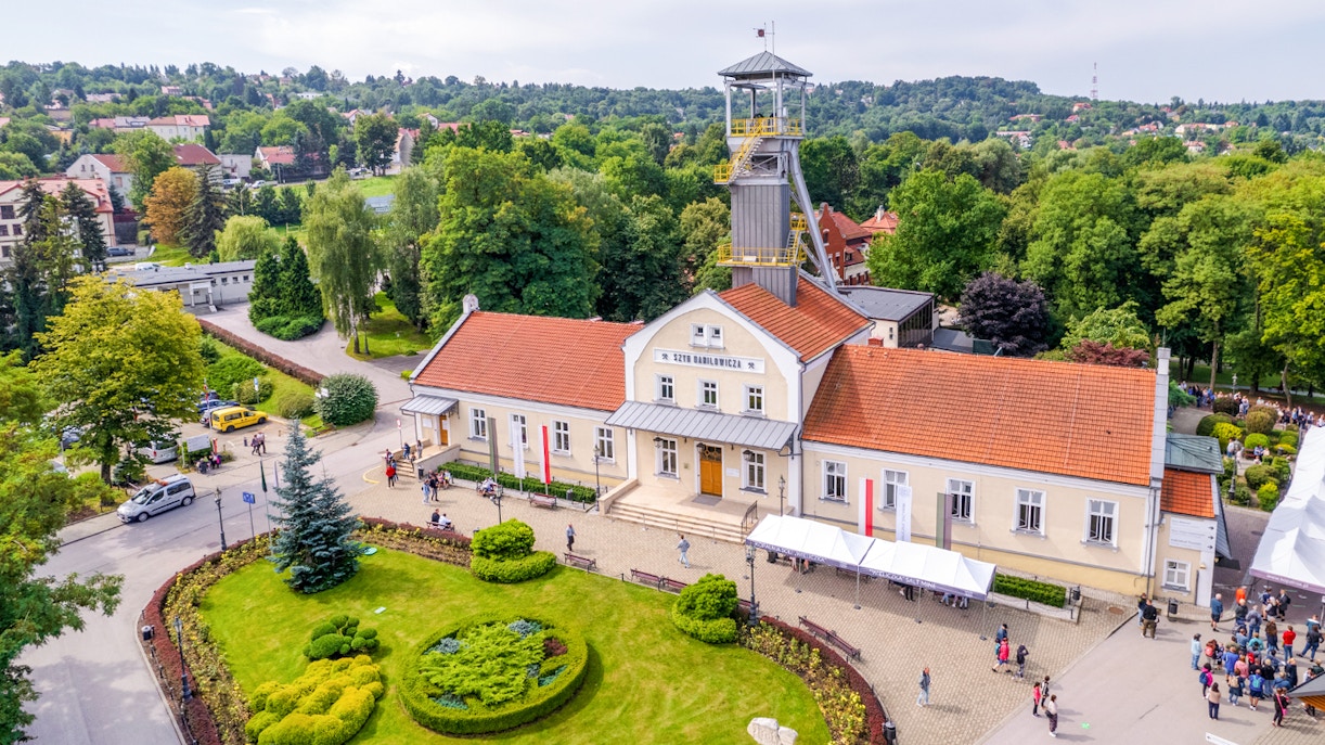 Aerial view of Wieliczka Salt Mine entrance with surrounding greenery and visitors.
