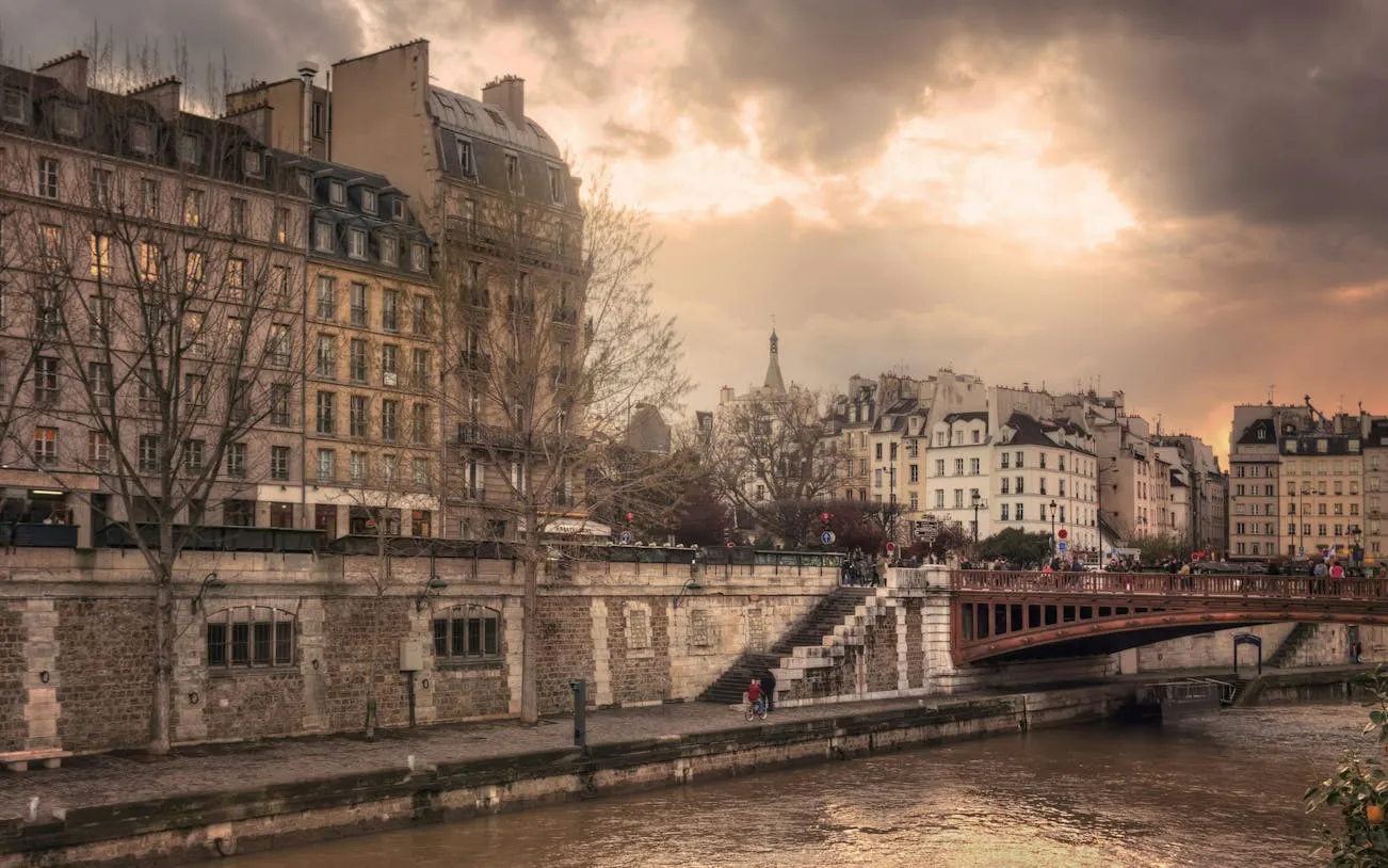 Seine River view with historic Parisian buildings and bridge, Paris Occupation & Liberation tour.