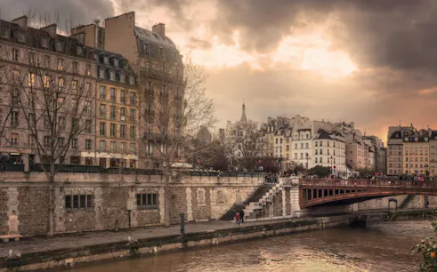 Seine River view with historic Parisian buildings and bridge, Paris Occupation & Liberation tour.