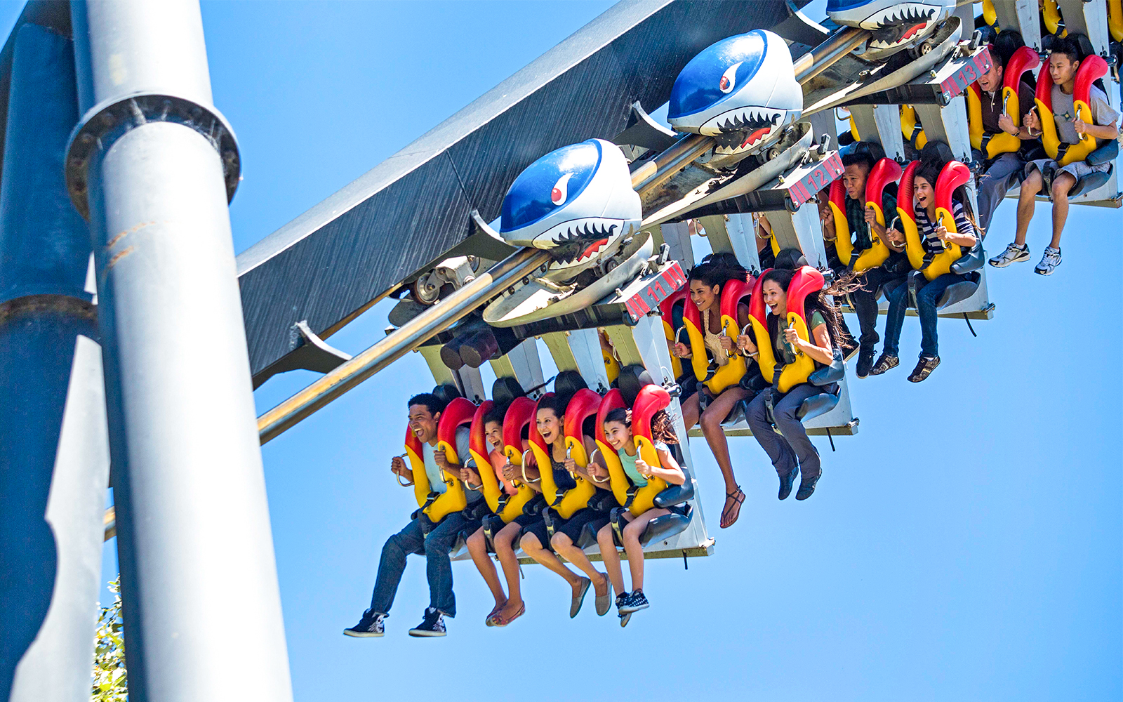 Riders on Flight Deck roller coaster at California's Great America, suspended upside down.