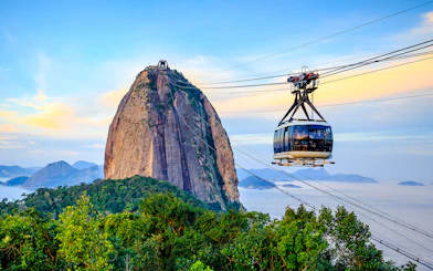 Cable car ascending Sugar Loaf Mountain, Rio de Janeiro, with ocean view.
