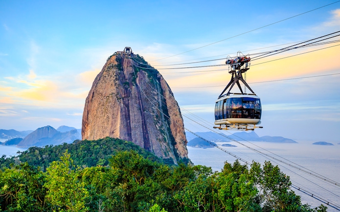Cable car ascending Sugar Loaf Mountain, Rio de Janeiro, with ocean view.