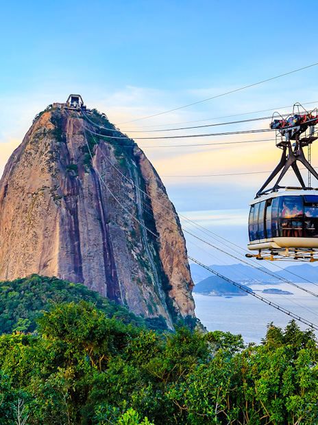 Cable car ascending Sugar Loaf Mountain, Rio de Janeiro, with ocean view.