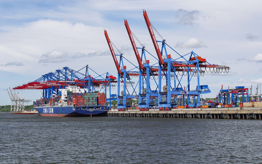 Container ship at Hamburg port near Elbphilharmonie during guided tour.