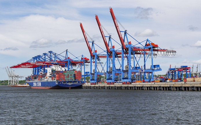 Container ship at Hamburg port near Elbphilharmonie during guided tour.