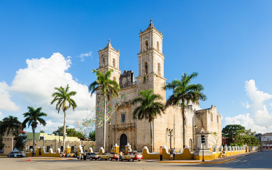 Spanish Cathedral Iglesia de San Servacio with palm trees in Valladolid, Mexico.