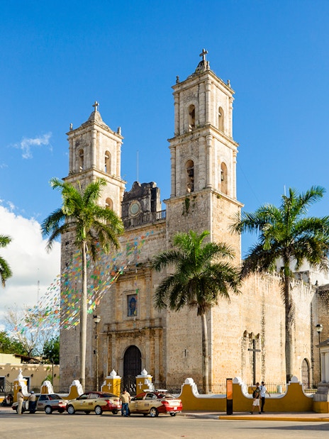 Spanish Cathedral Iglesia de San Servacio with palm trees in Valladolid, Mexico.
