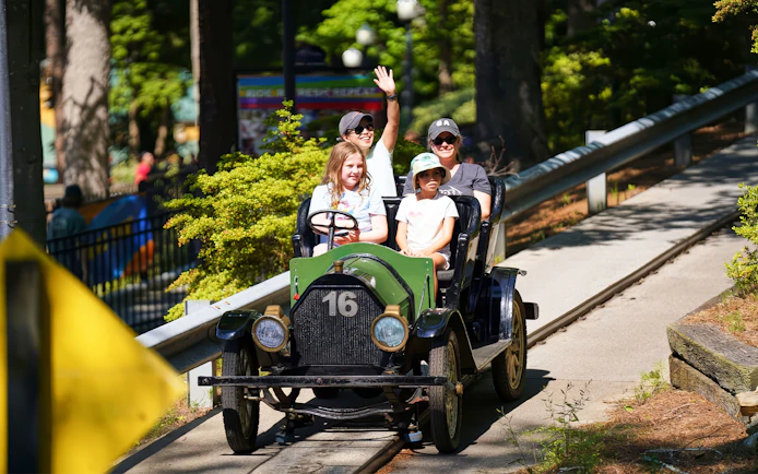Family enjoying Hanson Cars ride at Six Flags Over Georgia.