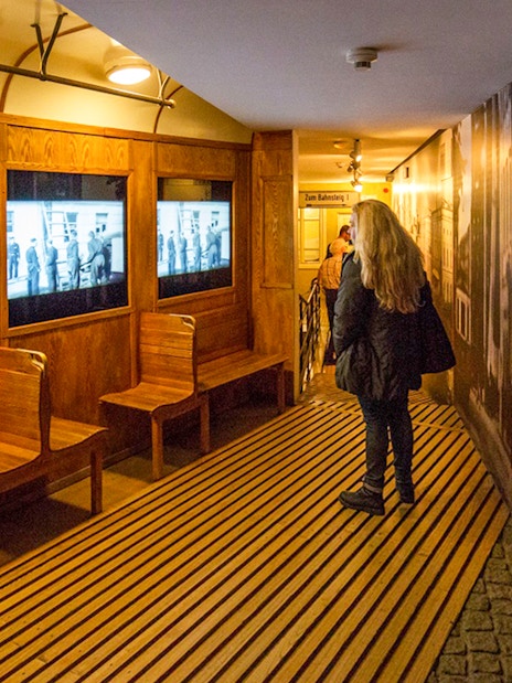 Visitor viewing historical displays at Schindler's Factory Museum, Krakow.