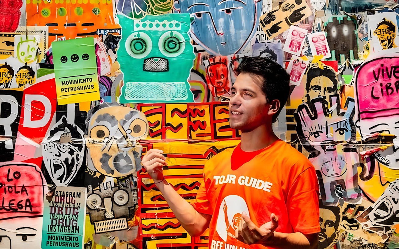Tour guide explaining vibrant graffiti art in Buenos Aires.