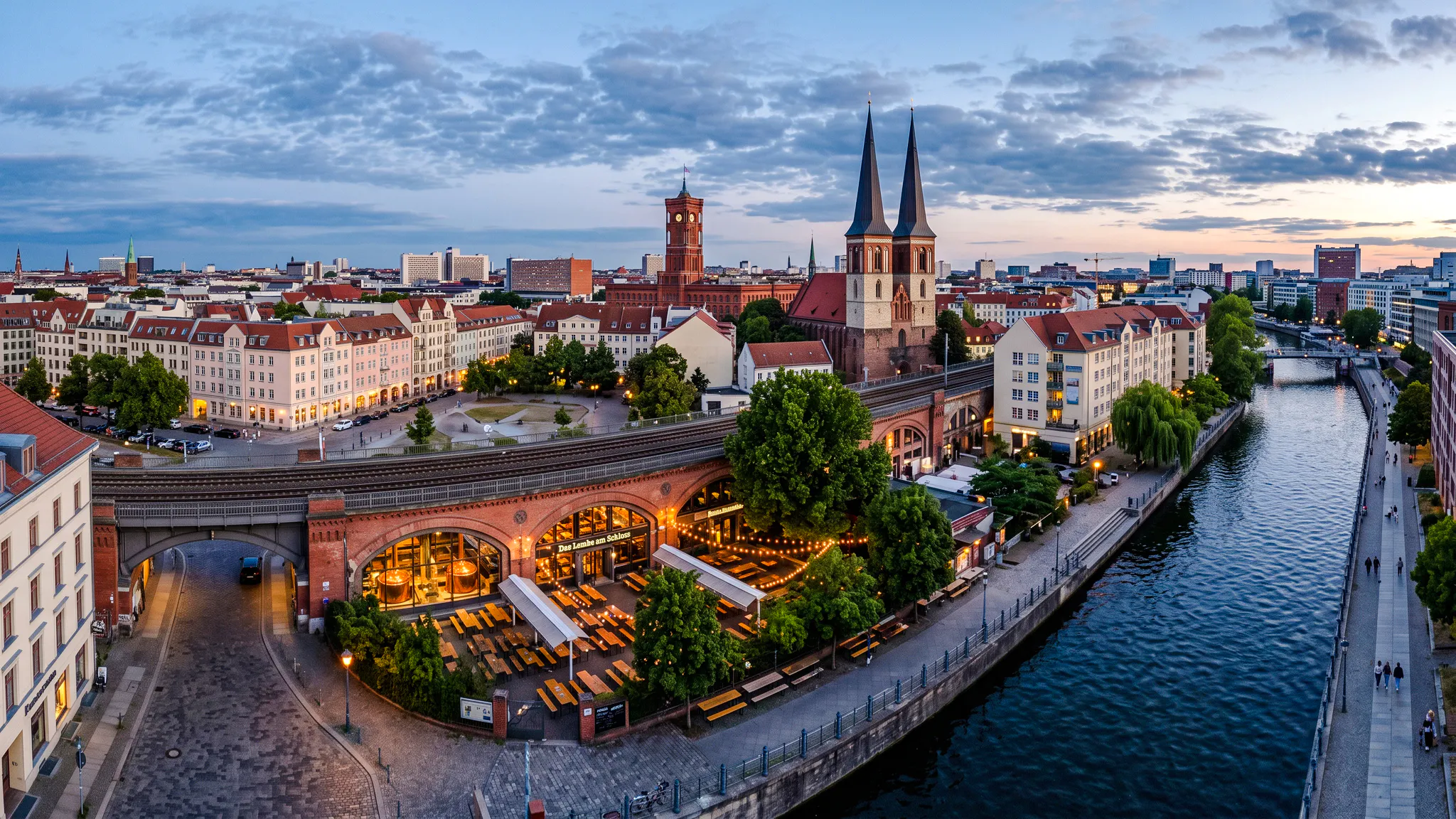 Berlin's historic district with breweries along the Spree River at dusk.
