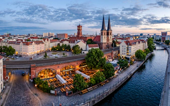 Berlin's historic district with breweries along the Spree River at dusk.