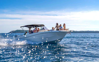 Guests on a speedboat tour enjoying views of the Blue Cave and Bay of Kotor.