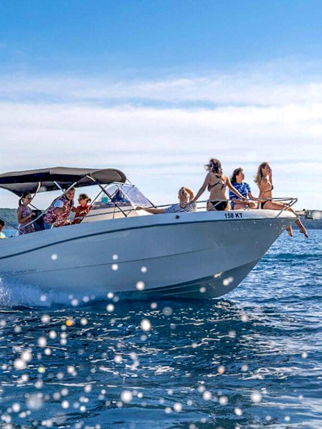 Guests on a speedboat tour enjoying views of the Blue Cave and Bay of Kotor.
