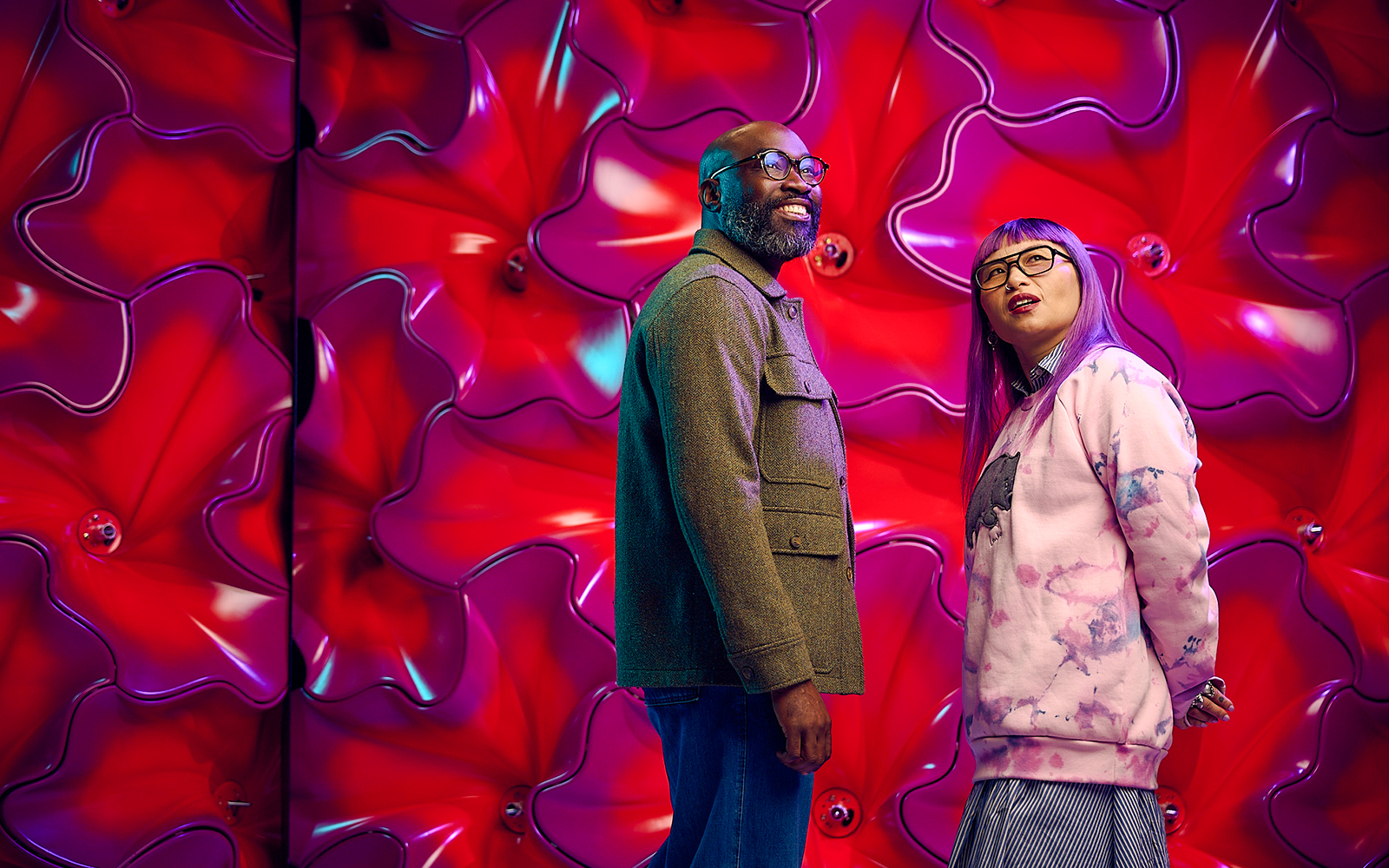 Visitors at Our Wondrous Planet exhibit, Melbourne Museum, with vibrant red backdrop.
