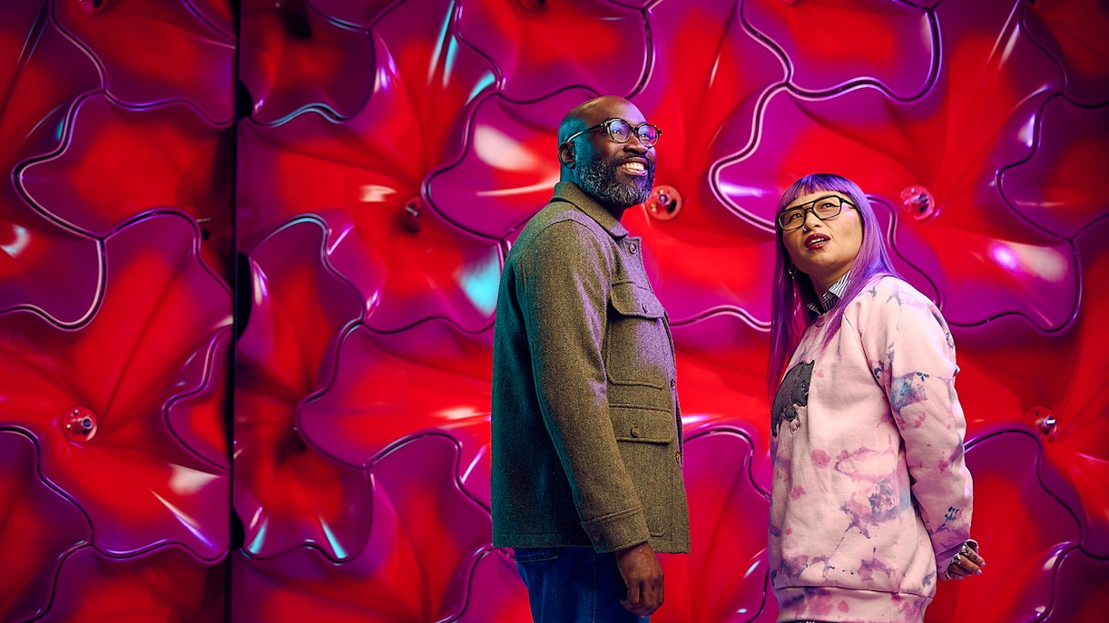 Visitors at Our Wondrous Planet exhibit, Melbourne Museum, with vibrant red backdrop.