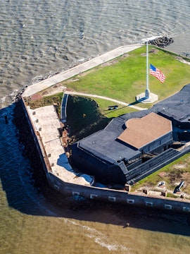 Aerial view of Fort Sumter National Monument with American flag, Charleston Harbor.