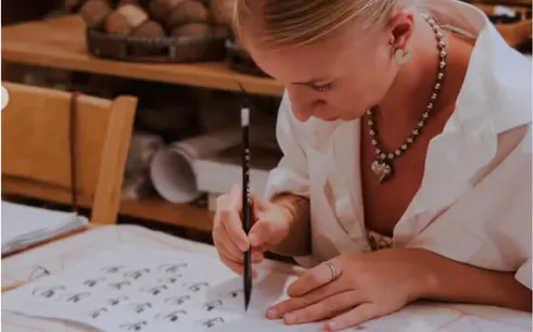 Person practicing calligraphy at a workshop in Da Nang, Vietnam.