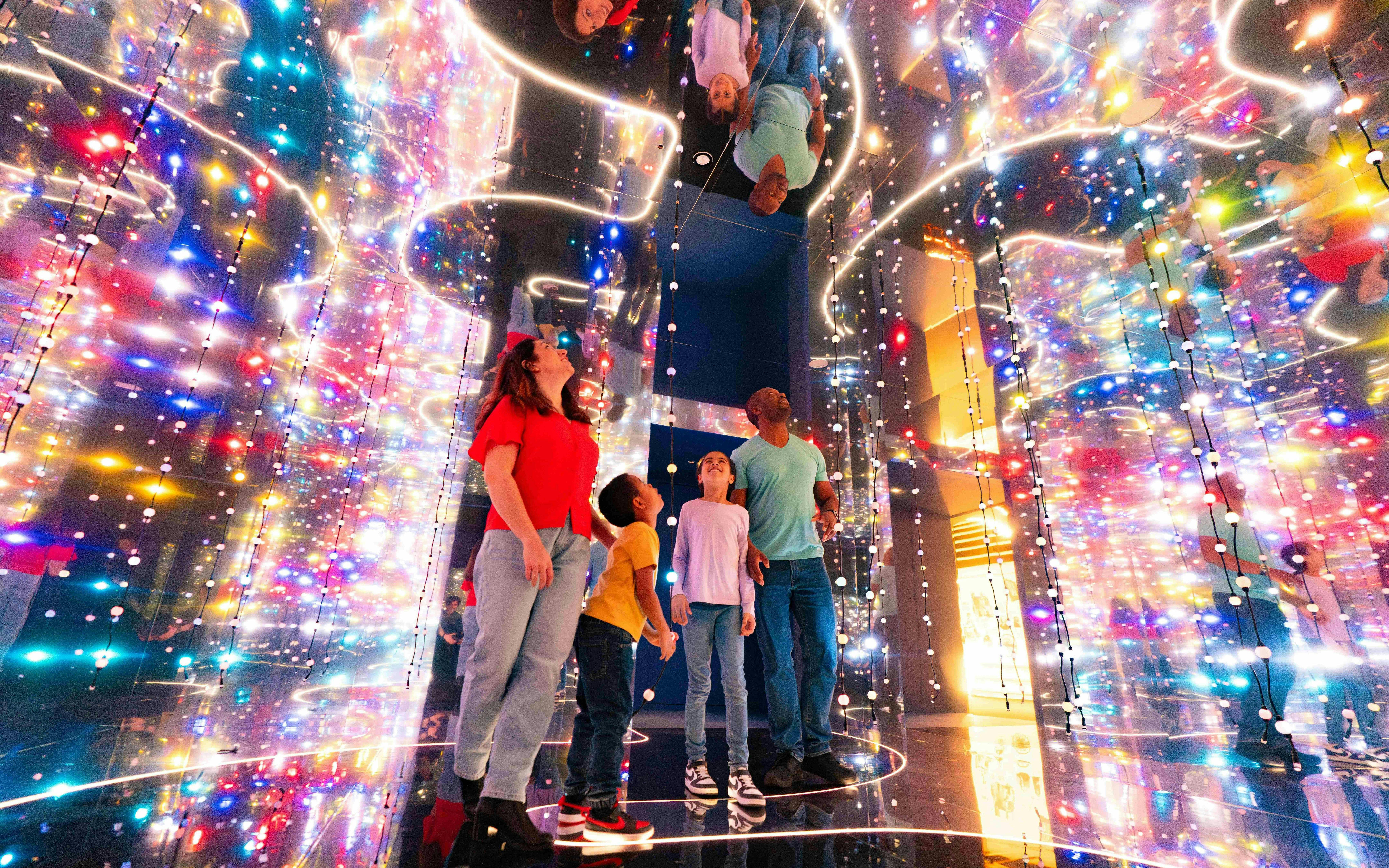 Guests exploring colorful light installation at the Astronomers Take Over, National Maritime Museum.