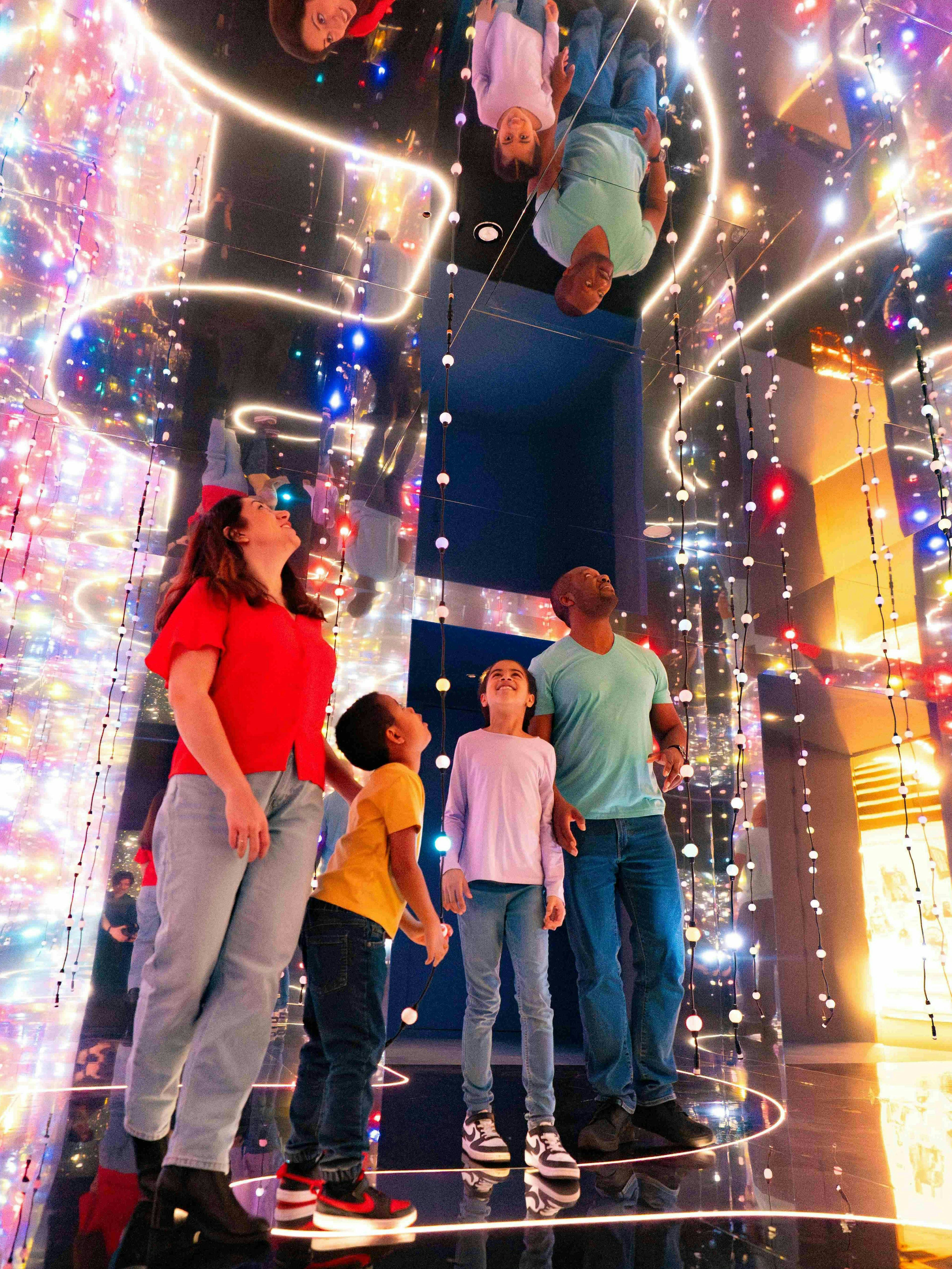 Guests exploring colorful light installation at the Astronomers Take Over, National Maritime Museum.
