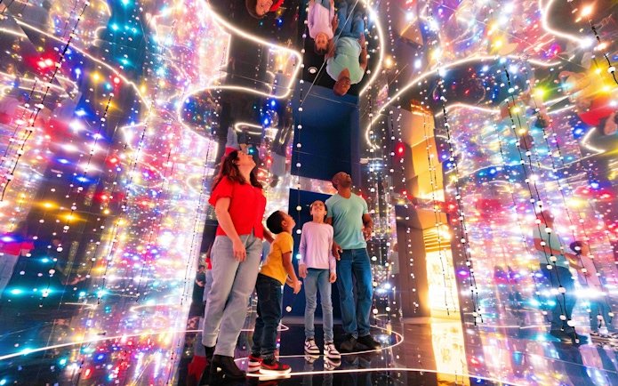 Guests exploring colorful light installation at the Astronomers Take Over, National Maritime Museum.