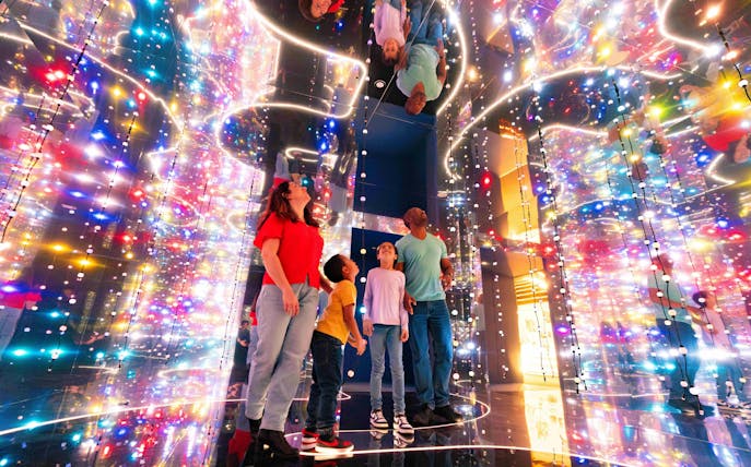 Guests exploring colorful light installation at the Astronomers Take Over, National Maritime Museum.