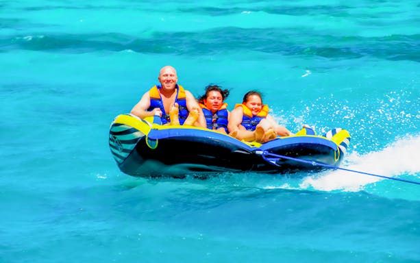 People enjoying a banana boat ride on a Dolphin Watching Cruise in Hurghada.