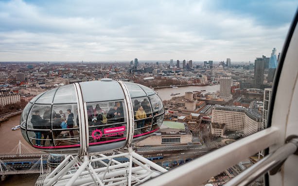 London Eye capsule overlooking Thames River and cityscape, part of combo tour with river cruise.