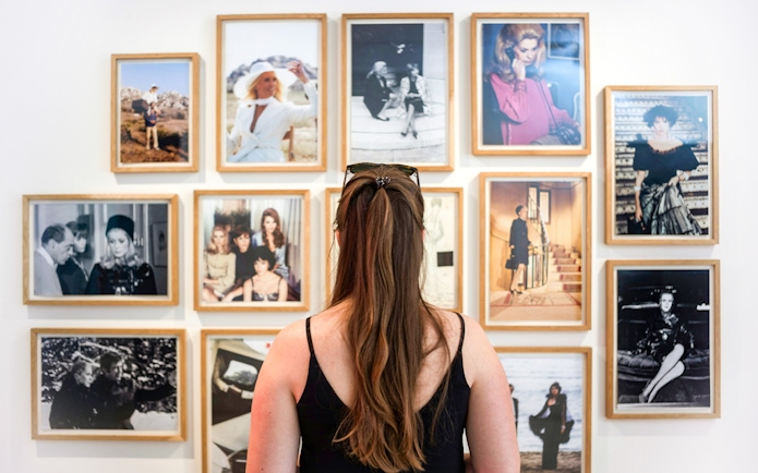 Visitor viewing fashion photography at Yves Saint Laurent Marrakesh Museum.
