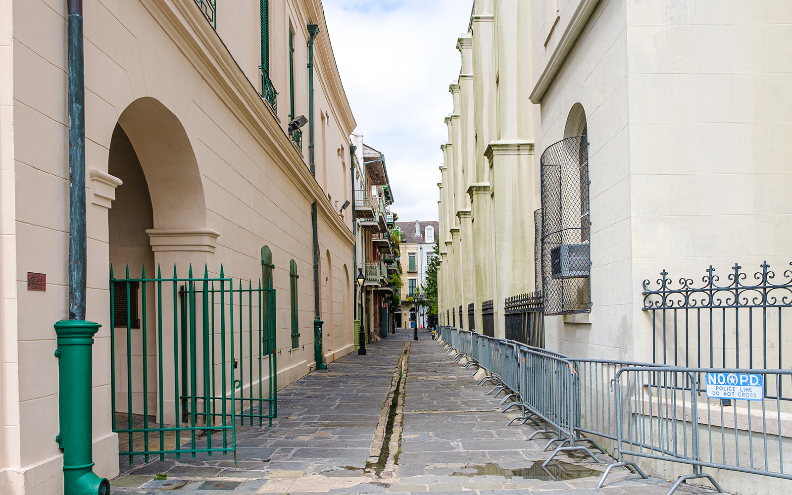 Narrow cobblestone alley in Pirate's Alley, French Quarter, New Orleans.