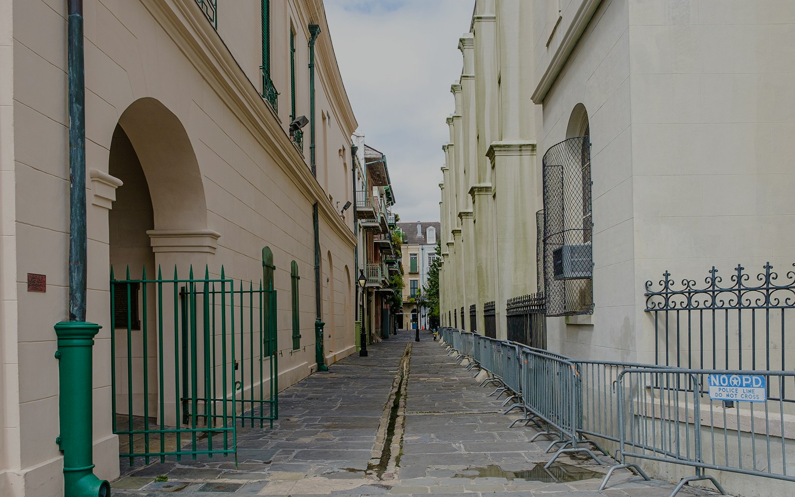 Narrow cobblestone alley in Pirate's Alley, French Quarter, New Orleans.