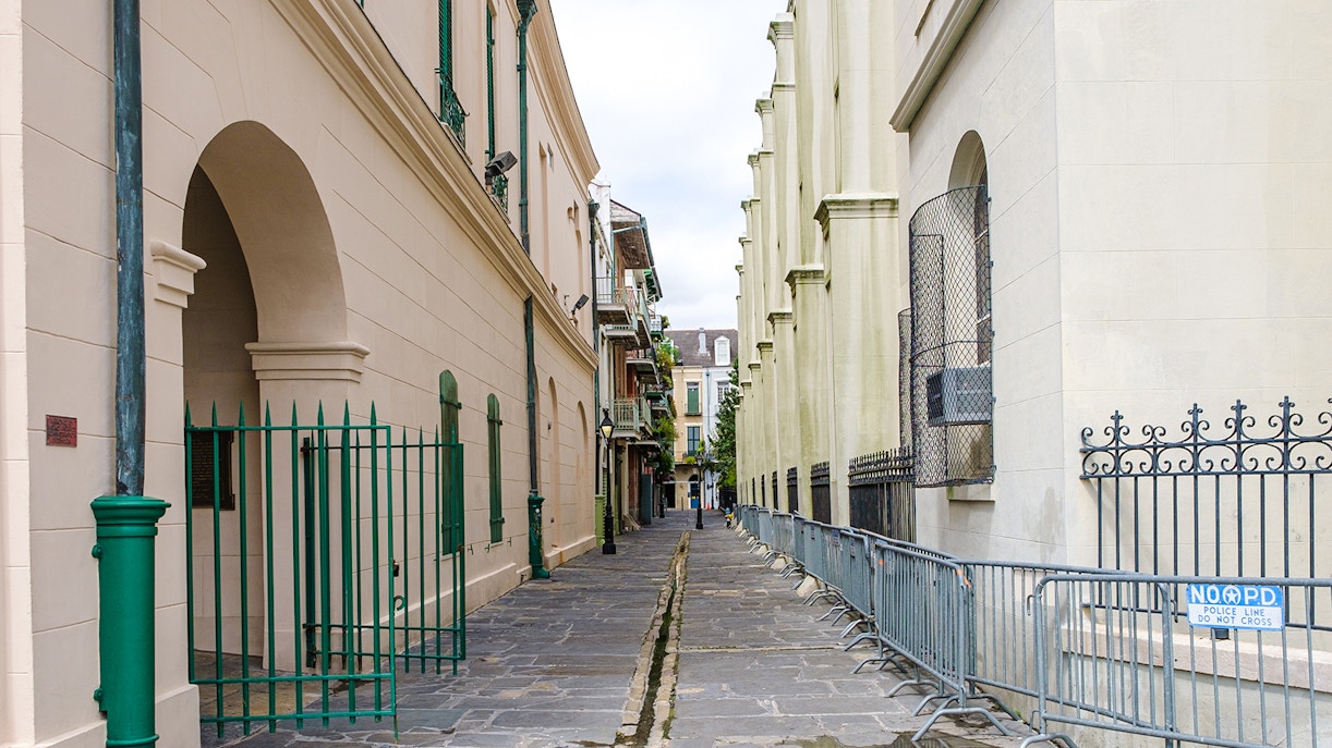 Narrow cobblestone alley in Pirate's Alley, French Quarter, New Orleans.