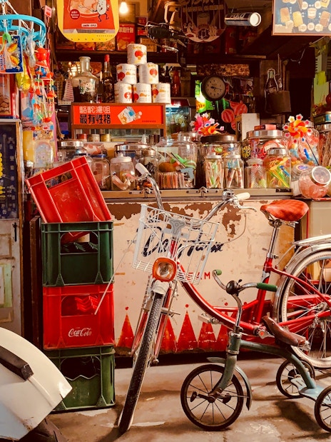 Storefront with vintage scooter and bicycle at Hong Kong Peak Tram & Sky Terrace.