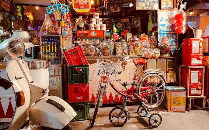 Storefront with vintage scooter and bicycle at Hong Kong Peak Tram & Sky Terrace.