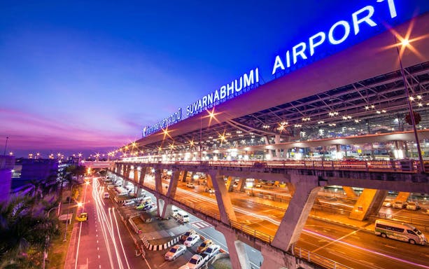 Suvarnabhumi Airport exterior at dusk, Pattaya private airport transfer service.