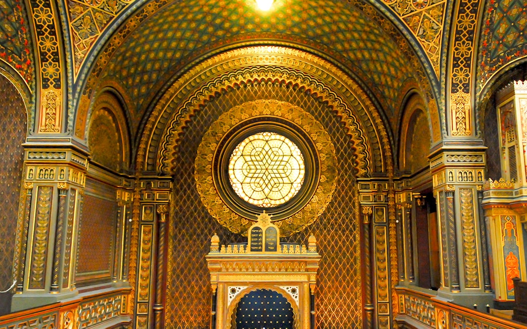 Interior of the Spanish Synagogue with ornate arches and stained glass window, Prague.