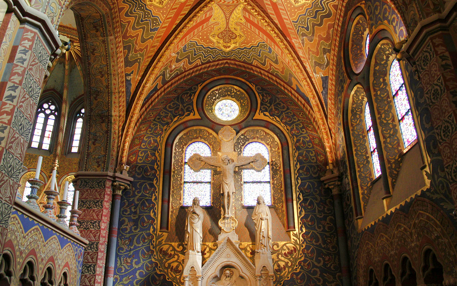 Chapel interior of Matthias Church with ornate stained glass and religious statues, Budapest, Hungary.