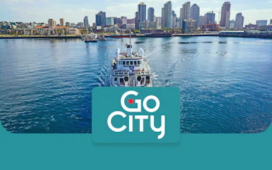 San Diego skyline with a tour boat on the bay, promoting Go San Diego Card.