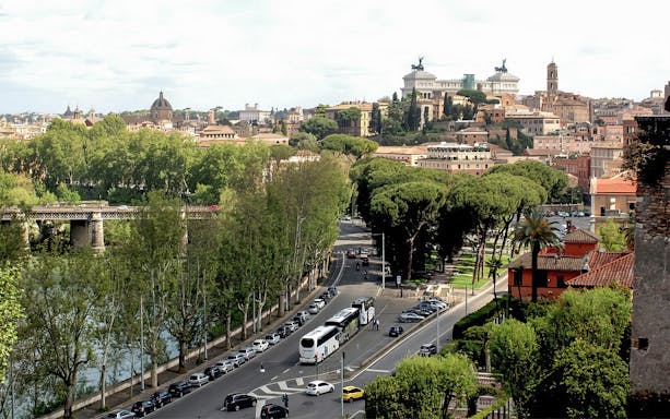 Rome cityscape with view of the Vittoriano and Tiber River, seen on a golf cart tour.