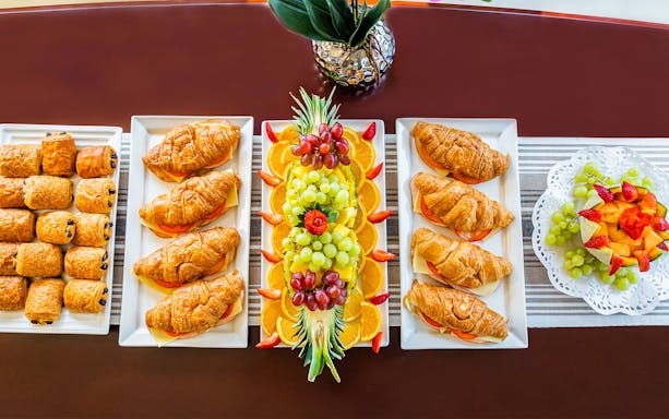 Assorted pastries and fruit platter on a luxury yacht in Dubai.